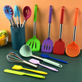 Colorful 14 piece silicone cooking utensil set arranged inside a matching countertop holder bucket